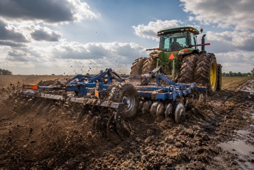Heavy-duty disc harrow operating in large-scale agricultural farming conditions